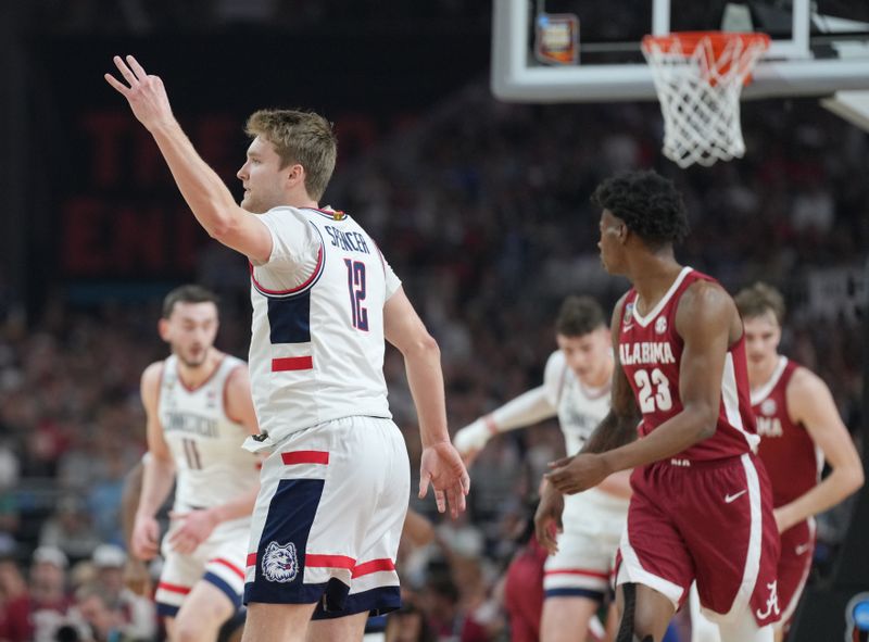 Apr 6, 2024; Glendale, AZ, USA; Connecticut Huskies guard Cam Spencer (12) reacts after a three pointer against the Alabama Crimson Tide in the semifinals of the men's Final Four of the 2024 NCAA Tournament at State Farm Stadium. Mandatory Credit: Robert Deutsch-USA TODAY Sports
