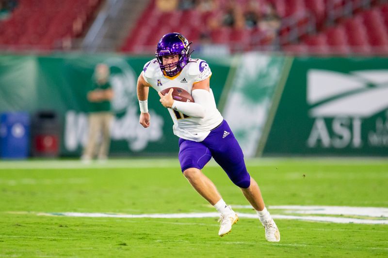 Oct 10, 2020; Tampa, Florida, USA;  East Carolina Pirates quarterback Holton Ahlers (12) rushes during the first quarter of a game against the South Florida Bulls at Raymond James Stadium. Mandatory Credit: Mary Holt-USA TODAY Sports