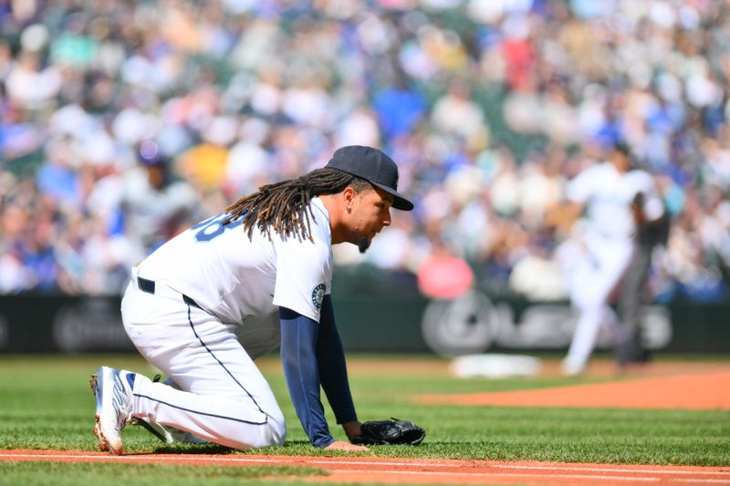 Apr 14, 2024; Seattle, Washington, USA; Seattle Mariners starting pitcher Luis Castillo (58) looks towards first base after committing an error during the first inning against the Chicago Cubs at T-Mobile Park. Mandatory Credit: Steven Bisig-USA TODAY Sports