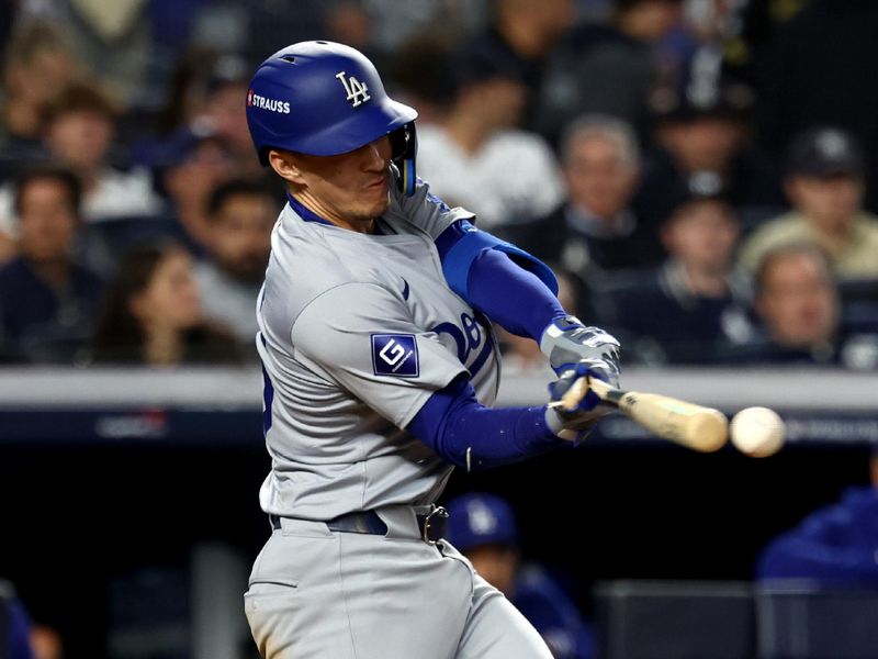 Oct 30, 2024; New York, New York, USA; Los Angeles Dodgers outfielder Tommy Edman (25) singles during the eighth inning against the New York Yankees in game five of the 2024 MLB World Series at Yankee Stadium. Mandatory Credit: Vincent Carchietta-Imagn Images