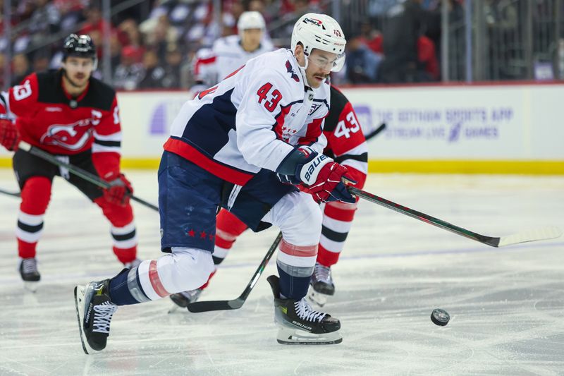 Nov 30, 2024; Newark, New Jersey, USA; Washington Capitals right wing Tom Wilson (43) skates with the puck against the New Jersey Devils during the first period at Prudential Center. Mandatory Credit: Thomas Salus-Imagn Images