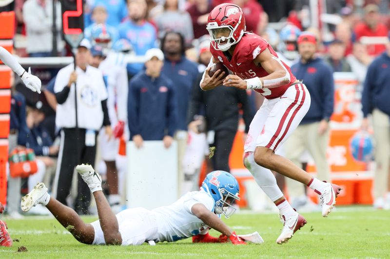 Nov 2, 2024; Fayetteville, Arkansas, USA; Arkansas Razorbacks quarterback Taylen Green (10) rushes against Ole Miss Rebels safety Louis Moore (7) during the first quarter at Donald W. Reynolds Razorback Stadium. Mandatory Credit: Nelson Chenault-Imagn Images