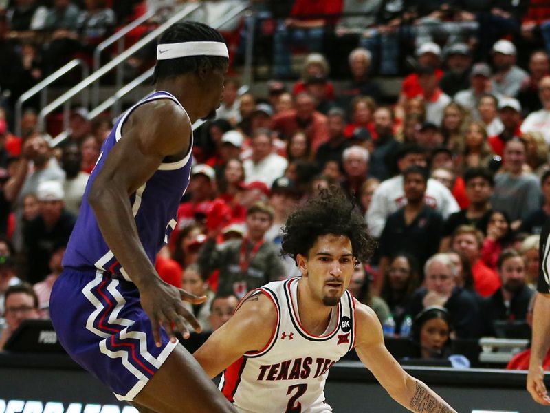 Feb 20, 2024; Lubbock, Texas, USA; Texas Tech Red Raiders guard Pop Isaacs (2) works the ball against TCU Horned Frogs guard Emanuel Miller (2) in the first half at United Supermarkets Arena. Mandatory Credit: Michael C. Johnson-USA TODAY Sports