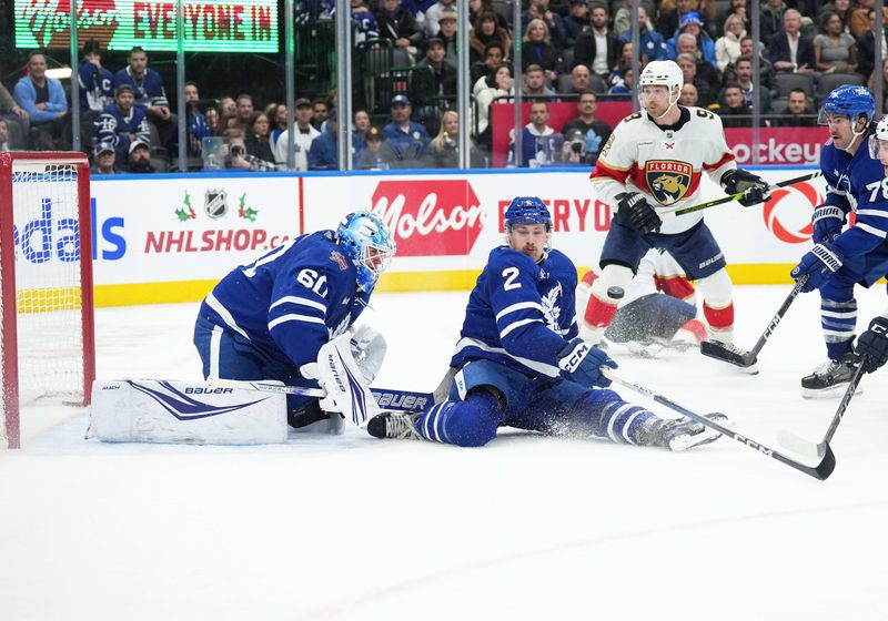 Nov 28, 2023; Toronto, Ontario, CAN; Toronto Maple Leafs defenceman Simon Benoit (2) tries to block a puck against the Florida Panthers during the overtime period at Scotiabank Arena. Mandatory Credit: Nick Turchiaro-USA TODAY Sports