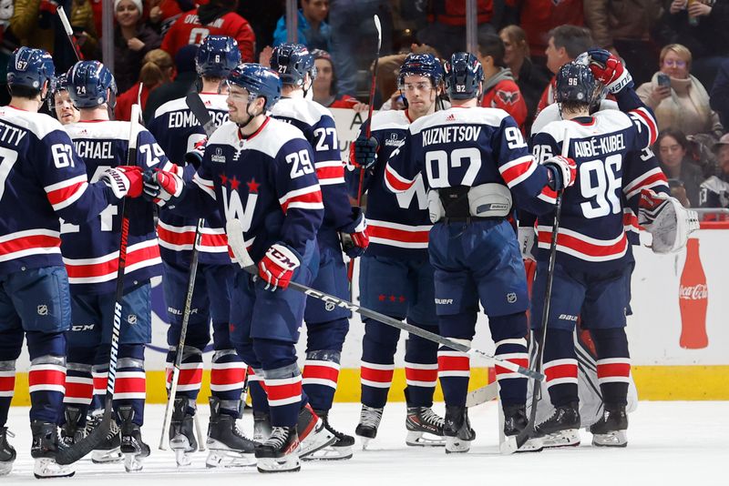 Jan 16, 2024; Washington, District of Columbia, USA; Washington Capitals players celebrate after their game against the Anaheim Ducks at Capital One Arena. Mandatory Credit: Geoff Burke-USA TODAY Sports