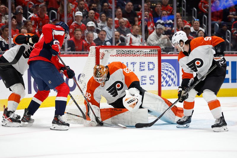 Oct 23, 2024; Washington, District of Columbia, USA; Philadelphia Flyers goaltender Ivan Fedotov (82) covers the puck in front of Washington Capitals center Dylan Strome (17) in the first period at Capital One Arena. Mandatory Credit: Geoff Burke-Imagn Images