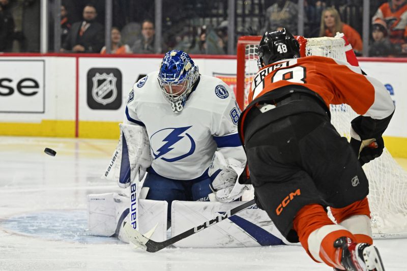 Jan 23, 2024; Philadelphia, Pennsylvania, USA; Tampa Bay Lightning goaltender Andrei Vasilevskiy (88) makes a save against Philadelphia Flyers center Morgan Frost (48) during the third period at Wells Fargo Center. Mandatory Credit: Eric Hartline-USA TODAY Sports