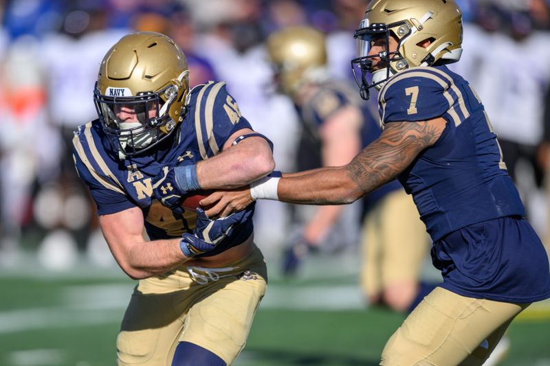 Nov 18, 2023; Annapolis, Maryland, USA; Navy Midshipmen quarterback Xavier Arline (7) hands the ball to Navy Midshipmen fullback Alex Tecza (46) during the third quarter against the East Carolina Pirates at Navy-Marine Corps Memorial Stadium. Mandatory Credit: Reggie Hildred-USA TODAY Sports