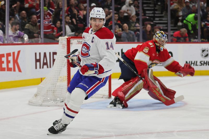 Feb 29, 2024; Sunrise, Florida, USA; Montreal Canadiens center Nick Suzuki (14) looks on after scoring against the Florida Panthers during the first period at Amerant Bank Arena. Mandatory Credit: Sam Navarro-USA TODAY Sports