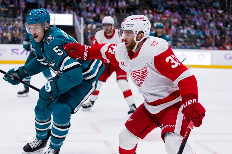 Nov 2, 2025; San Jose, California, USA;  Detroit Red Wings left wing J.T. Compher (37) and San Jose Sharks defenseman Vincent Desharnais (5) battle for possession during the first period at SAP Center at San Jose. Mandatory Credit: John Hefti-Imagn Images