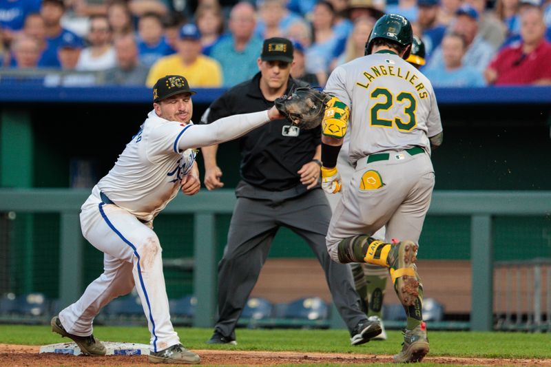 May 18, 2024; Kansas City, Missouri, USA; Kansas City Royals first base Vinnie Pasquantino (9) reaches to tag Oakland Athletics catcher Shea Langeliers (23) during the seventh inning at Kauffman Stadium. Mandatory Credit: William Purnell-USA TODAY Sports