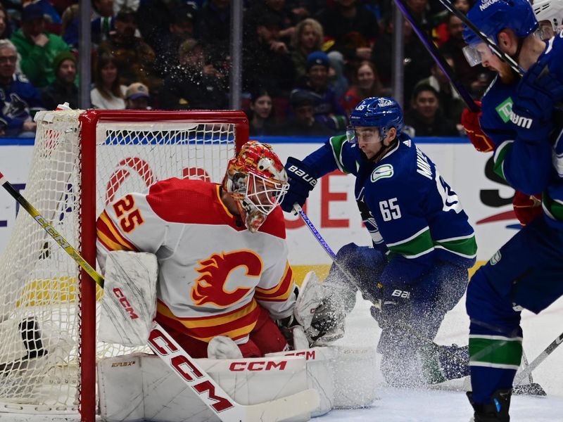 Mar 23, 2024; Vancouver, British Columbia, CAN; Vancouver Canucks forward Ilya Mikheyev (65) challenges Calgary Flames goaltender Jacob Markstrom (25) during the first period at Rogers Arena. Mandatory Credit: Simon Fearn-USA TODAY Sports