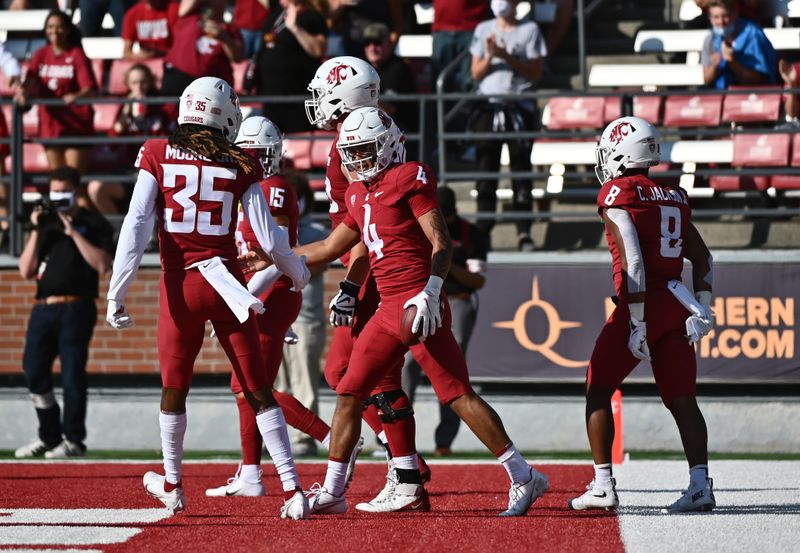 Sep 11, 2021; Pullman, Washington, USA; Washington State Cougars quarterback Jayden de Laura (4) and teammate CJ Moore celebrate after a score against the Portland State Vikings in the first half at Gesa Field at Martin Stadium. Mandatory Credit: James Snook-USA TODAY Sports