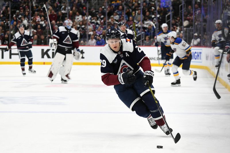 Jan 31, 2025; Denver, Colorado, USA; Colorado Avalanche center Nathan MacKinnon (29) skates for a loose puck on a delayed penalty during the second period against the St. Louis Blues at Ball Arena. Mandatory Credit: Christopher Hanewinckel-Imagn Images