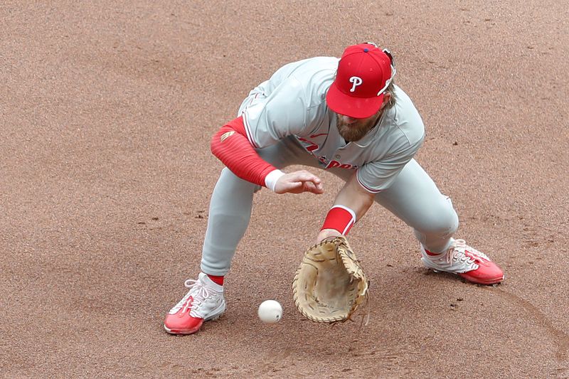 Jul 21, 2024; Pittsburgh, Pennsylvania, USA;  Philadelphia Phillies first baseman Bryce Harper (3) fields a ground ball for an out against Pittsburgh Pirates right fielder Joshua Palacios (not pictured) during the fifth inning at PNC Park.  The Phillies won 6-0. Mandatory Credit: Charles LeClaire-USA TODAY Sports