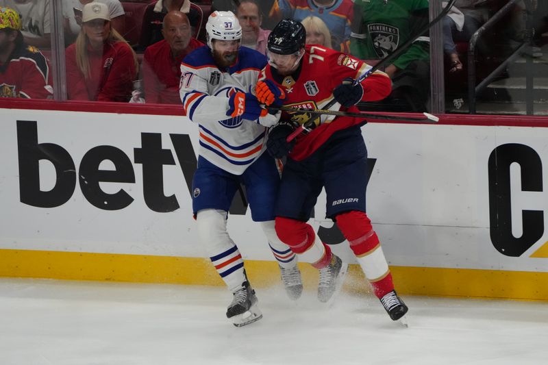 Jun 24, 2024; Sunrise, Florida, USA; Florida Panthers defenseman Niko Mikkola (77) checks Edmonton Oilers defenseman Brett Kulak (27) during the first period in game seven of the 2024 Stanley Cup Final at Amerant Bank Arena. Mandatory Credit: Jim Rassol-USA TODAY Sports