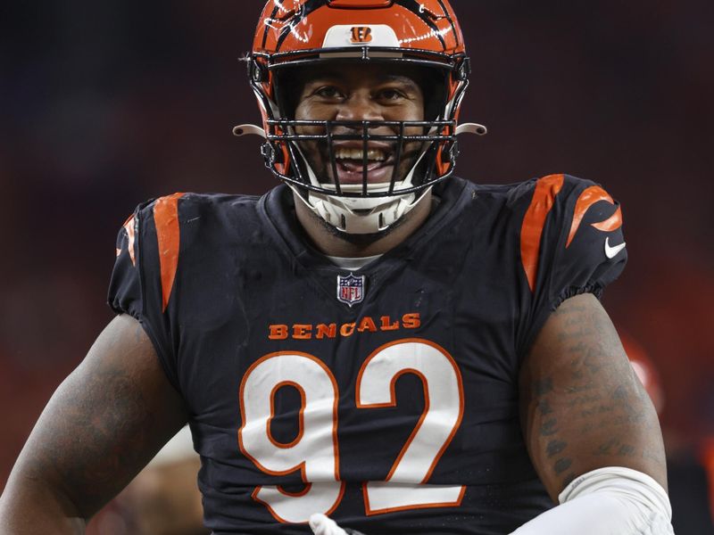 Cincinnati Bengals defensive tackle BJ Hill (92) mimes rocking a baby in celebration of a sack during an NFL football game against the Buffalo Bills, Sunday, Nov. 5, 2023, in Cincinnati. (AP Photo/Gary McCullough)