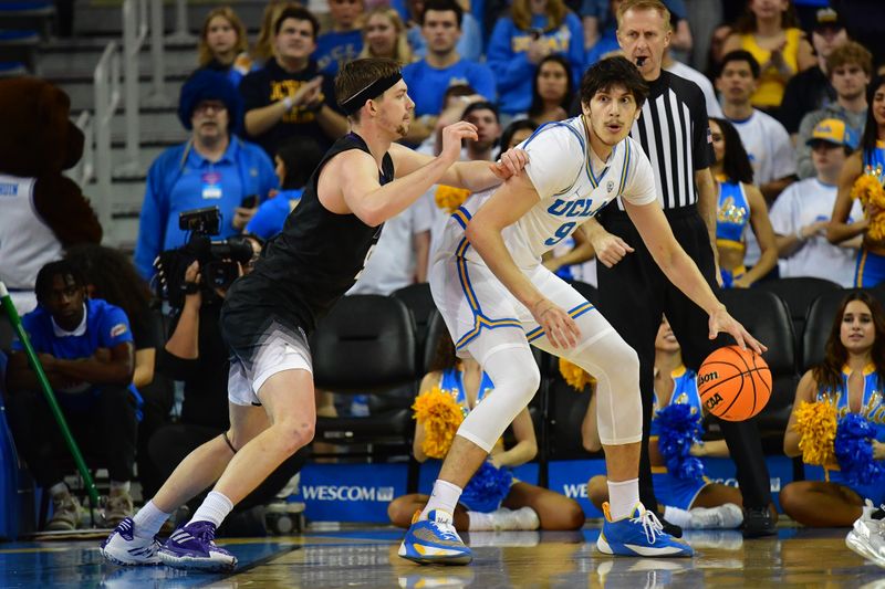 January 14, 2024; Los Angeles, California, USA; UCLA Bruins forward Berke Buyuktuncel (9) moves the ball against Washington Huskies guard Paul Mulcahy (9) during the first half at Pauley Pavilion. Mandatory Credit: Gary A. Vasquez-USA TODAY Sports