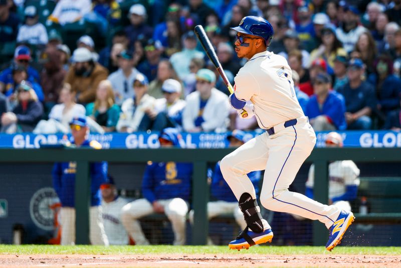 Apr 13, 2025; Seattle, Washington, USA; Seattle Mariners designated hitter Jorge Polanco (7) hits a single against the Texas Rangers during the first inning at T-Mobile Park. Mandatory Credit: Joe Nicholson-Imagn Images