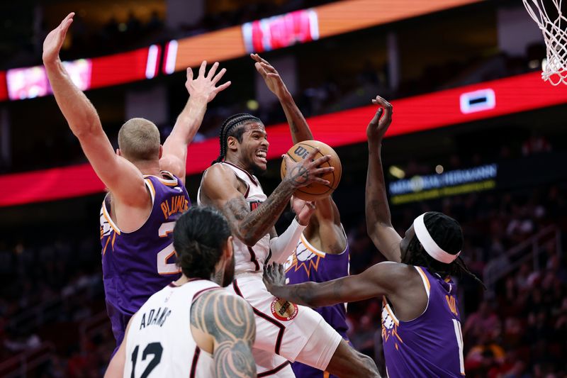 HOUSTON, TEXAS - FEBRUARY 12: Jalen Green #4 of the Houston Rockets drives against Bol Bol #11 of the Phoenix Suns during the first half at Toyota Center on February 12, 2025 in Houston, Texas. NOTE TO USER: User expressly acknowledges and agrees that, by downloading and or using this photograph, User is consenting to the terms and conditions of the Getty Images License Agreement. (Photo by Alex Slitz/Getty Images)