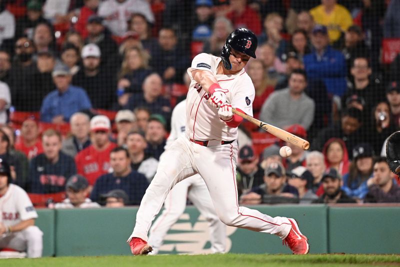 May 30, 2024; Boston, Massachusetts, USA; Boston Red Sox catcher Reese McGuire (3) hits a single against the Detroit Tigers during the eighth inning at Fenway Park. Mandatory Credit: Eric Canha-USA TODAY Sports