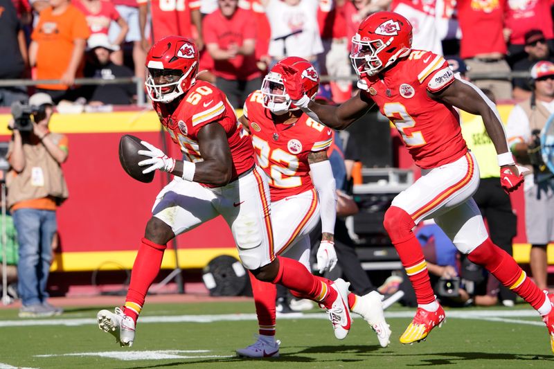 Kansas City Chiefs linebacker Willie Gay (50) celebrates after recovering a fumble alongside teammates Trent McDuffie (22) and Joshua Williams (2) during the first half of an NFL football game against the Chicago Bears Sunday, Sept. 24, 2023, in Kansas City, Mo. (AP Photo/Ed Zurga)