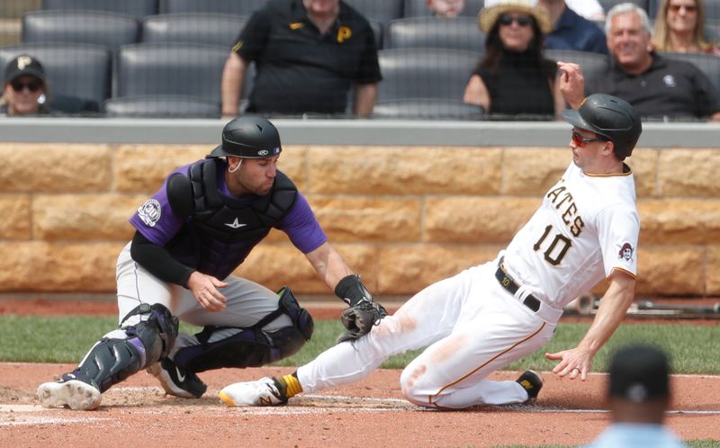 May 10, 2023; Pittsburgh, Pennsylvania, USA;  Colorado Rockies catcher Austin Wynns (16) tags Pittsburgh Pirates left fielder Bryan Reynolds (10) out at home plate attempting to score during the sixth inning at PNC Park. Mandatory Credit: Charles LeClaire-USA TODAY Sports