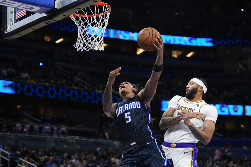 ORLANDO, FLORIDA - NOVEMBER 04: Anthony Davis #3 of the Los Angeles Lakers fouls Paolo Banchero #5 of the Orlando Magic during the second half at Amway Center on November 04, 2023 in Orlando, Florida. NOTE TO USER: User expressly acknowledges and agrees that, by downloading and or using this photograph, User is consenting to the terms and conditions of the Getty Images License Agreement. (Photo by Rich Storry/Getty Images)