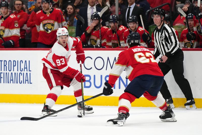 Jan 17, 2024; Sunrise, Florida, USA; Detroit Red Wings right wing Alex DeBrincat (93) controls the puck around Florida Panthers defenseman Brandon Montour (62) during the first period at Amerant Bank Arena. Mandatory Credit: Jasen Vinlove-USA TODAY Sports