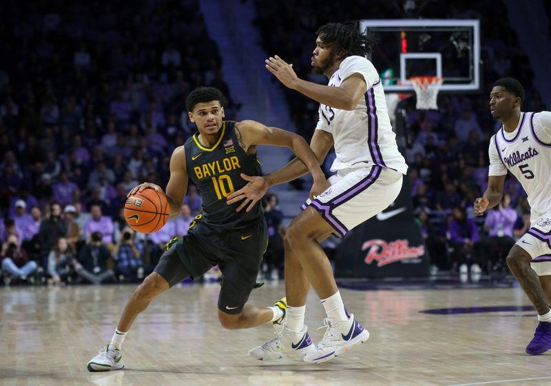 Jan 16, 2024; Manhattan, Kansas, USA; Baylor Bears guard RayJ Dennis (10) is guarded by Kansas State Wildcats center Will McNair Jr. (13) during the second half at Bramlage Coliseum. Mandatory Credit: Scott Sewell-USA TODAY Sports