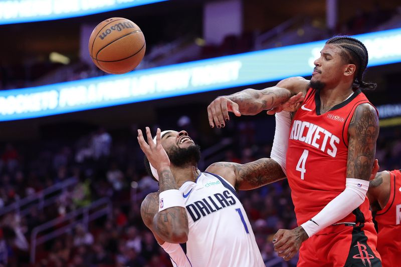 HOUSTON, TEXAS - JANUARY 01: Jalen Green #4 of the Houston Rockets blocks a shot from Jaden Hardy #1 of the Dallas Mavericks during the first half at Toyota Center on January 01, 2025 in Houston, Texas. NOTE TO USER: User expressly acknowledges and agrees that, by downloading and or using this photograph, User is consenting to the terms and conditions of the Getty Images License Agreement. (Photo by Alex Slitz/Getty Images)