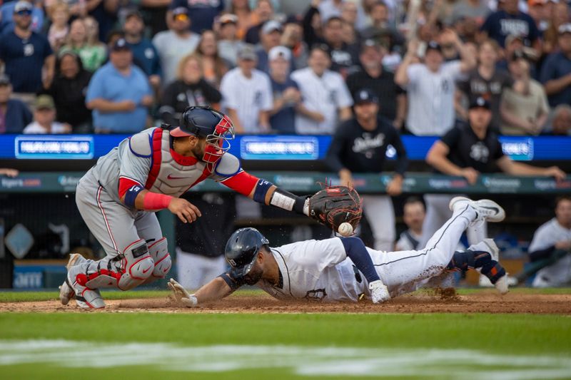 Jun 11, 2024; Detroit, Michigan, USA; Detroit Tigers outfielder Riley Greene (31) scores a run in the fifth inning and beats the throw to Washington Nationals catcher Keibert Ruiz (20) at Comerica Park. Mandatory Credit: David Reginek-USA TODAY Sports