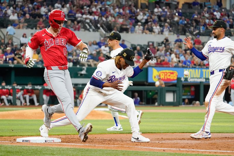 May 18, 2024; Arlington, Texas, USA; Los Angeles Angels right fielder Mickey Moniak (16) reaches first base on a fielding error by Texas Rangers pitcher Jose Urena (54) during the second inning at Globe Life Field. Mandatory Credit: Raymond Carlin III-USA TODAY Sports