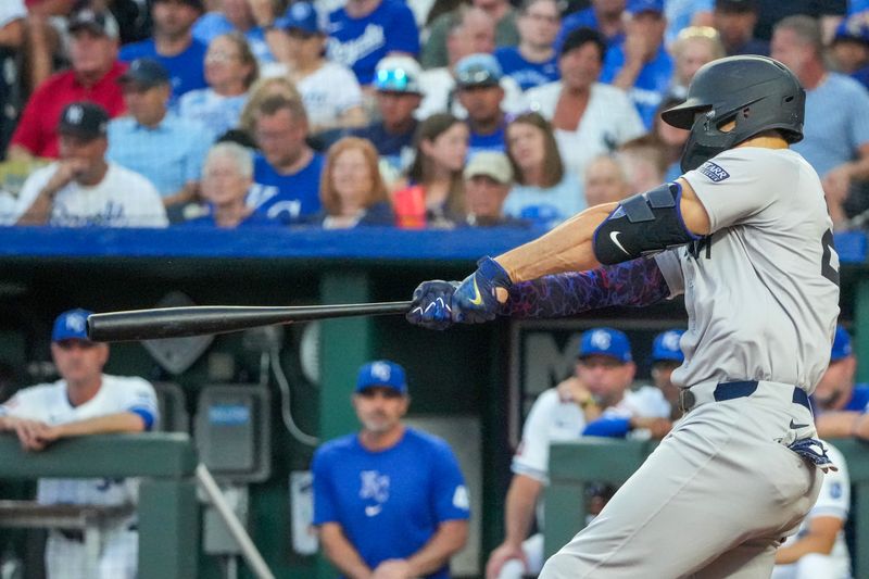 Jun 12, 2024; Kansas City, Missouri, USA; New York Yankees designated hitter Giancarlo Stanton (27) hits a two run home run against the Kansas City Royals in the fifth inning at Kauffman Stadium. Mandatory Credit: Denny Medley-USA TODAY Sports