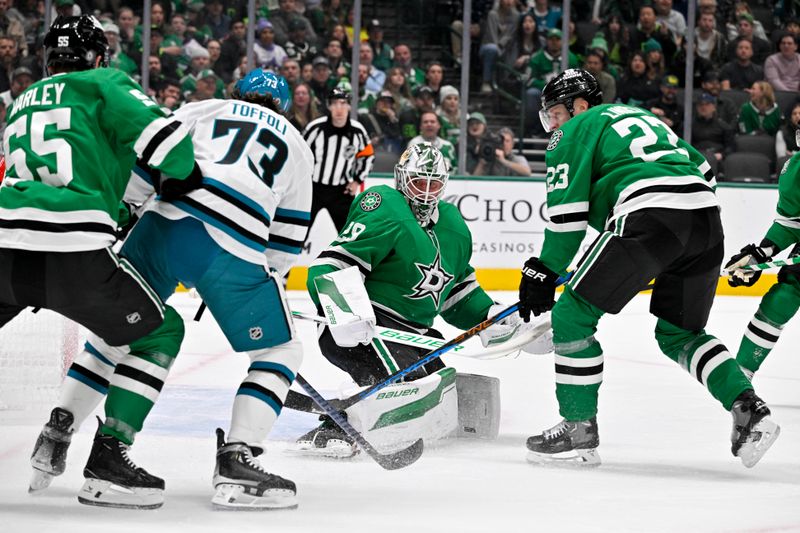 Nov 20, 2024; Dallas, Texas, USA; Dallas Stars goaltender Jake Oettinger (29) stops a shot by San Jose Sharks center Tyler Toffoli (73) during the first period at the American Airlines Center. Mandatory Credit: Jerome Miron-Imagn Images