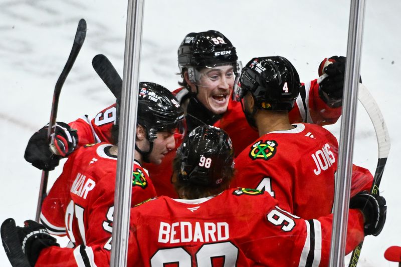 Jan 18, 2025; Chicago, Illinois, USA;  Chicago Blackhawks left wing Tyler Bertuzzi (59) celebrates with  defenseman Seth Jones (4) after he scores against the Vegas Golden Knights during the second period at United Center. Mandatory Credit: Matt Marton-Imagn Images