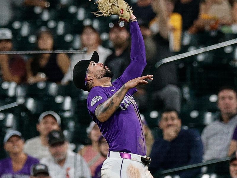 Sep 3, 2025; Denver, Colorado, USA; Colorado Rockies first baseman Warming Bernabel (25) makes a catch for an out in the fifth inning against the San Francisco Giants at Coors Field. Mandatory Credit: Isaiah J. Downing-Imagn Images