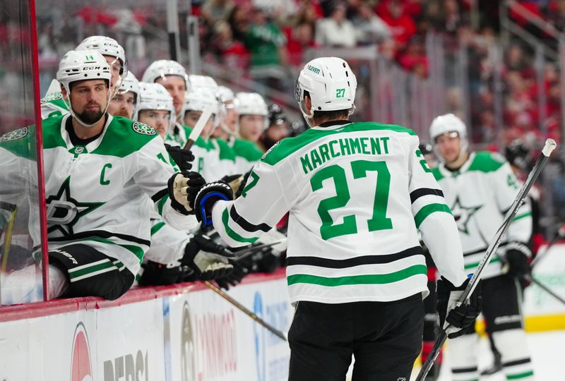 Nov 25, 2024; Raleigh, North Carolina, USA;  Dallas Stars left wing Mason Marchment (27) is congratulated by left wing Jamie Benn (14) after his goal against the Carolina Hurricanes during the second period at Lenovo Center. Mandatory Credit: James Guillory-Imagn Images