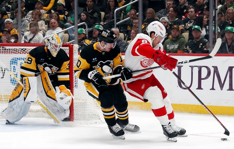 Mar 17, 2024; Pittsburgh, Pennsylvania, USA;  Pittsburgh Penguins left wing Drew O'Connor (10) commits a hooking penalty against Detroit Red Wings defenseman Ben Chiarot (8) during the second period at PPG Paints Arena.  Pittsburgh won 6-3.Mandatory Credit: Charles LeClaire-USA TODAY Sports