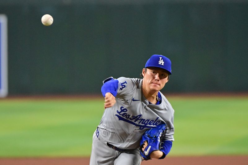 May 1, 2024; Phoenix, Arizona, USA;  Los Angeles Dodgers pitcher Yoshinobu Yamamoto (18) throws in the third inning against the Arizona Diamondbacks at Chase Field. Mandatory Credit: Matt Kartozian-USA TODAY Sports
