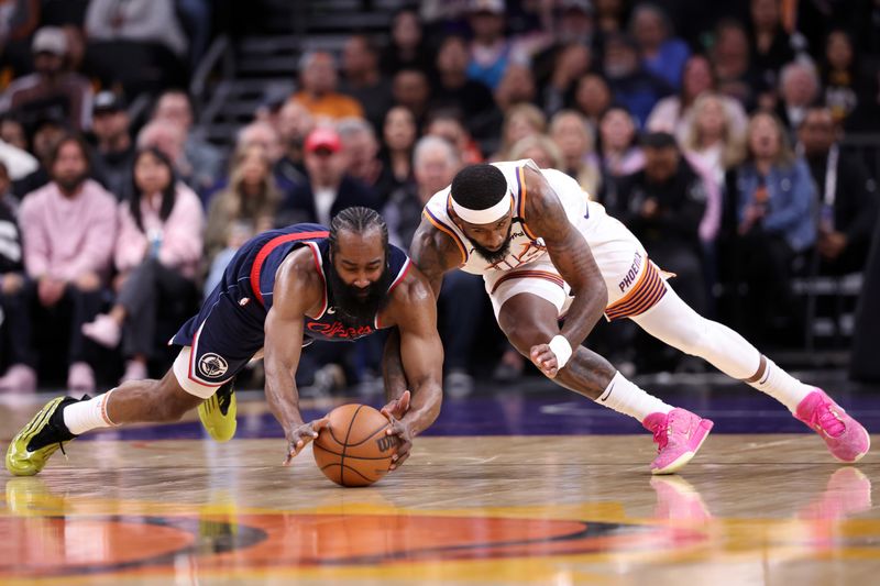 PHOENIX, ARIZONA - JANUARY 27: Royce O'Neale #00 of the Phoenix Suns and James Harden #1 of the LA Clippers battle for a loose ball during the first half at Footprint Center on January 27, 2025 in Phoenix, Arizona. NOTE TO USER: User expressly acknowledges and agrees that, by downloading and or using this photograph, User is consenting to the terms and conditions of the Getty Images License Agreement.  (Photo by Chris Coduto/Getty Images)