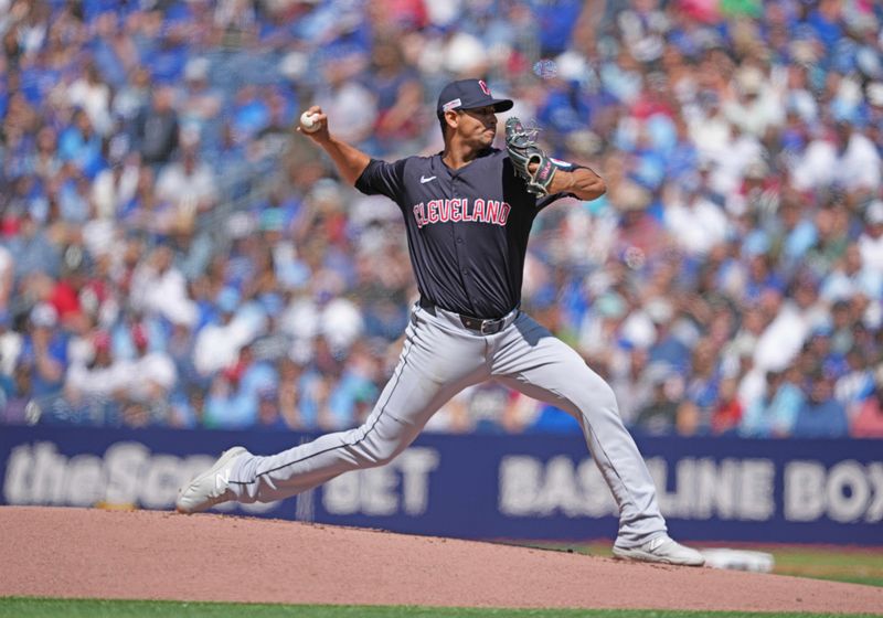 Jun 15, 2024; Toronto, Ontario, CAN; Cleveland Guardians starting pitcher Carlos Carrasco (59) throws a pitch against the Toronto Blue Jays during the first inning at Rogers Centre. Mandatory Credit: Nick Turchiaro-USA TODAY Sports