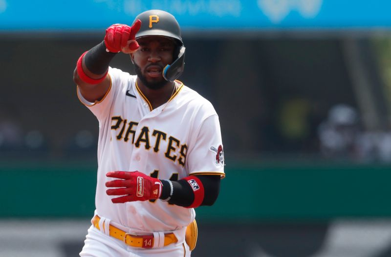 Jun 7, 2023; Pittsburgh, Pennsylvania, USA;  Pittsburgh Pirates shortstop Rodolfo Castro (14) gestures as he circles the bases after hitting a solo home run against the Oakland Athletics during the second inning at PNC Park. Mandatory Credit: Charles LeClaire-USA TODAY Sports