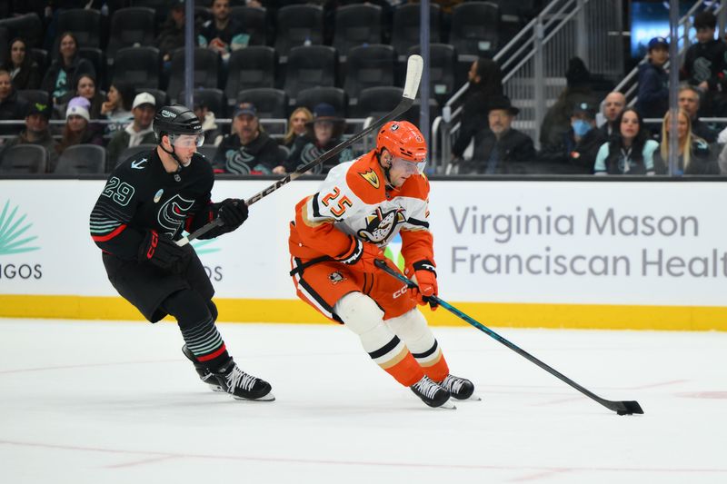 Jan 23, 2026; Seattle, Washington, USA; Anaheim Ducks center Ryan Poehling (25) advances the puck while defended by Seattle Kraken defenseman Vince Dunn (29) during the first period at Climate Pledge Arena. Mandatory Credit: Steven Bisig-Imagn Images