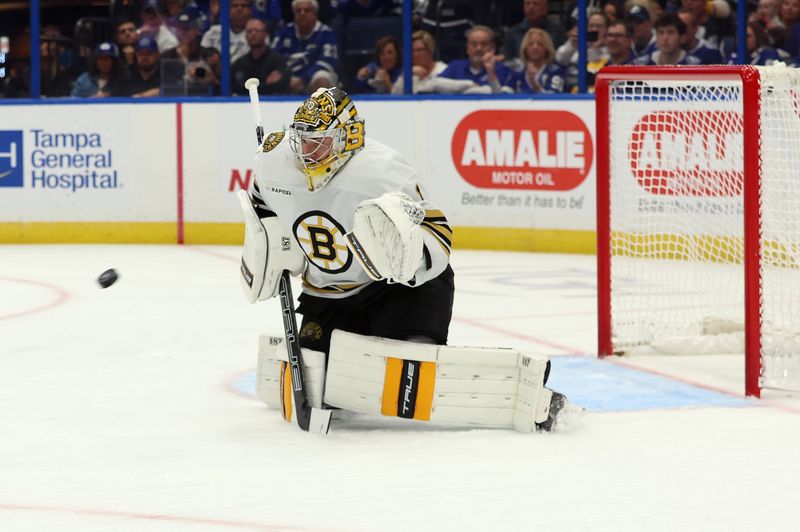 Nov 20, 2023; Tampa, Florida, USA; Boston Bruins goaltender Jeremy Swayman (1) makes a save against the Tampa Bay Lightning during the first period at Amalie Arena. Mandatory Credit: Kim Klement Neitzel-USA TODAY Sports