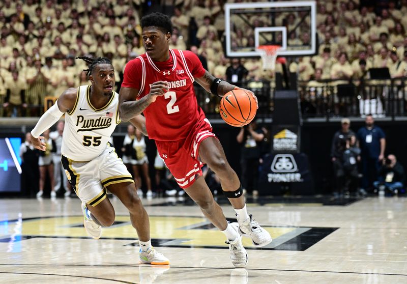 Mar 10, 2024; West Lafayette, Indiana, USA; Wisconsin Badgers guard AJ Storr (2) drives the ball toward the basket around Purdue Boilermakers guard Lance Jones (55) during the first half at Mackey Arena. Mandatory Credit: Marc Lebryk-USA TODAY Sports