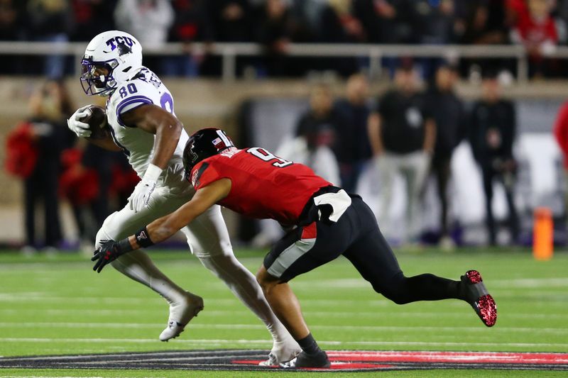 Nov 2, 2023; Lubbock, Texas, USA; Texas Tech Red Raiders defensive back CJ Baskerville (9) prepares to tackle Texas Christian Horned Frogs tight end DJ Rogers (80) in the second half at Jones AT&T Stadium and Cody Campbell Field. Mandatory Credit: Michael C. Johnson-USA TODAY Sports