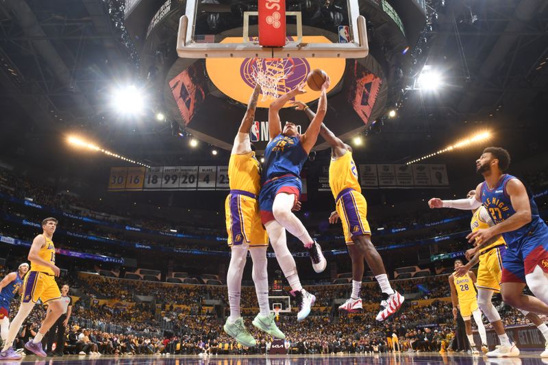 LOS ANGELES, CA - APRIL 25: Nikola Jokic #15 of the Denver Nuggets drives to the basket during the game against the Los Angeles Lakers during Round 1 Game 3 of the 2024 NBA Playoffs on April 25, 2024 at Crypto.Com Arena in Los Angeles, California. NOTE TO USER: User expressly acknowledges and agrees that, by downloading and/or using this Photograph, user is consenting to the terms and conditions of the Getty Images License Agreement. Mandatory Copyright Notice: Copyright 2024 NBAE (Photo by Andrew D. Bernstein/NBAE via Getty Images)