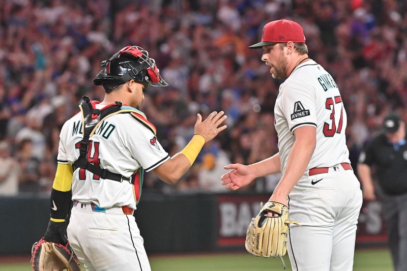 May 8, 2025; Phoenix, Arizona, USA; Arizona Diamondbacks catcher Gabriel Moreno (14) celebrates with pitcher Kevin Ginkel (37) after beating the Los Angeles Dodgers at Chase Field. Mandatory Credit: Matt Kartozian-Imagn Images