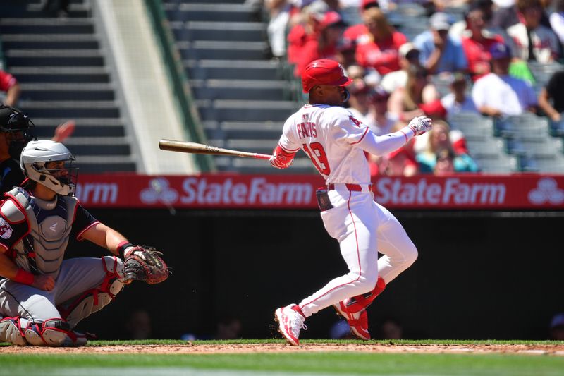 Apr 6, 2025; Anaheim, California, USA; Los Angeles Angels second baseman Kyren Paris (19) hits a single against the Cleveland Guardians during the second inning at Angel Stadium. Mandatory Credit: Gary A. Vasquez-Imagn Images